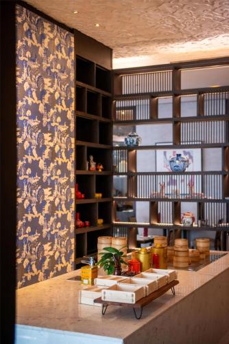 a room with a wall with paintings on it at Radisson Blu Plaza Bangkok in Bangkok