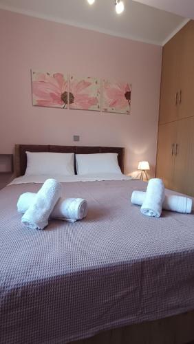 a bedroom with a large bed with two pillows on it at GK Apartment in Kalavrita