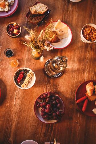 a wooden table with plates of food on it at L'Escale (accès en télécabine) in Châtel