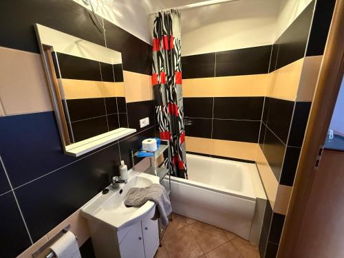 a bathroom with a sink and a bath tub at VITA Augustów in Augustów