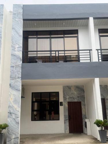 a view of a house with a balcony at Casa Noah in Maribago