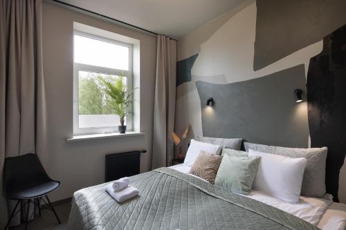 a bedroom with a large bed with a window at RixStay Apartments in Rīga