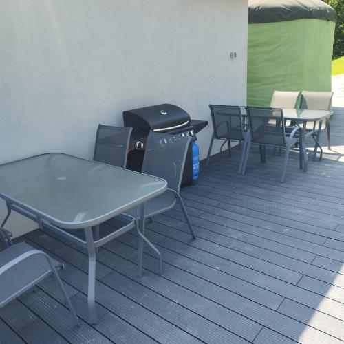 a group of tables and chairs on a patio at Jeżowa Woda Ośrodek Wypoczynkowy Palmiarnia i SPA in Przyszowa