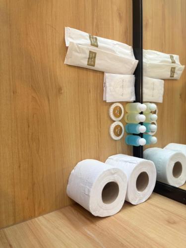 a pile of rolls of toilet paper next to a mirror at Terpenica in Pattaya