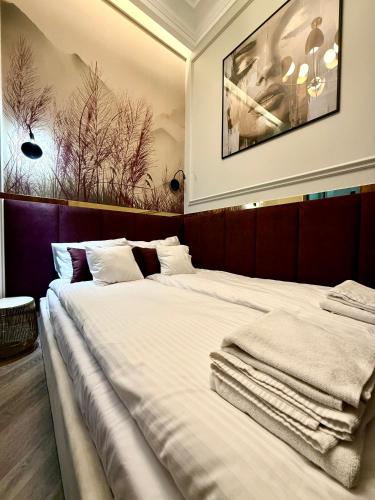 a bedroom with two beds with towels on them at ROOSEVELTA RESIDENCE Apartments - przy OFF Piotrkowska in Łódź
