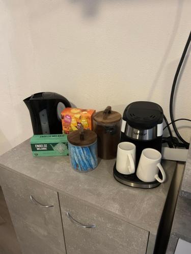 a counter with a coffee maker and cups on it at Vlinder 2pers studio in Utrecht