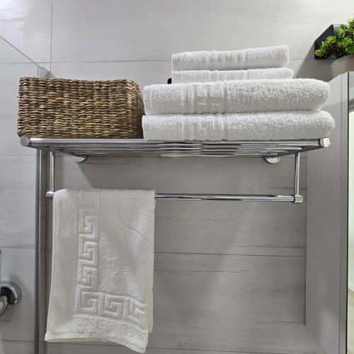 a towel rack with towels on it in a bathroom at Studio Tabacariei 5A in Tăbăcărie