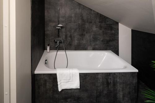 a bathroom with a white bath tub in a room at RixStay Apartments in Rīga