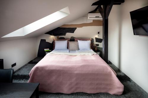 a bedroom with a large bed in a attic at RixStay Apartments in Rīga