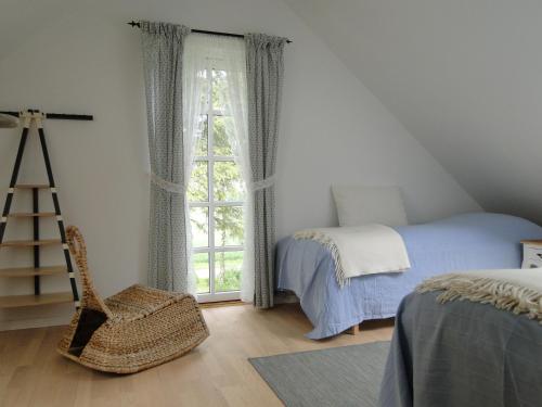 a bedroom with a bed and a window at Dyssegaard Holiday Apartment in Skallerup