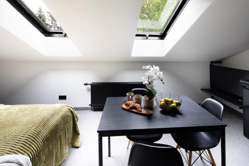 a bedroom with a table with a bowl of fruit on it at RixStay Apartments in Rīga