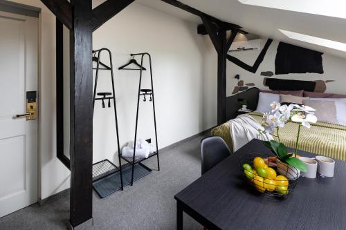 a room with a table with a bowl of fruit on it at RixStay Apartments in Rīga