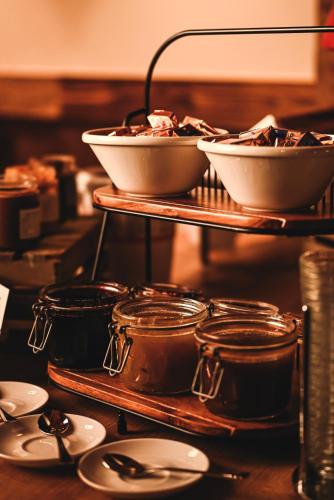 a group of bowls and spoons on a shelf with dishes at L'Escale (accès en télécabine) in Châtel