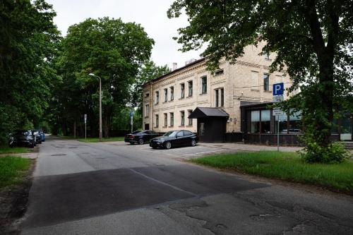 a street with cars parked in front of a building at RixStay Apartments in Rīga