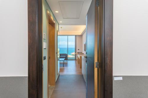 a hallway leading to a room with a view of the ocean at Jounieh Living - Residences by Local Host in Ed Dkârîne