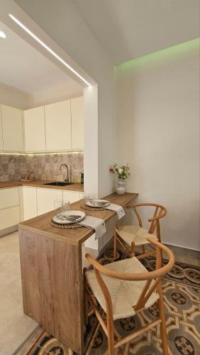 a kitchen with a table and chairs and a sink at Serenata in Corfu Town