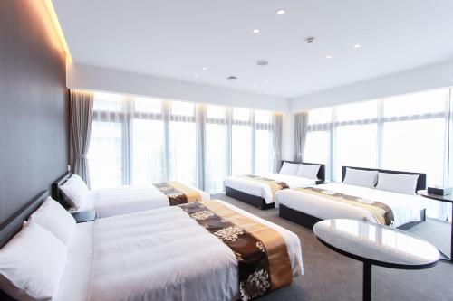 Ένα ή περισσότερα κρεβάτια σε δωμάτιο στο The Arbor HOTEL