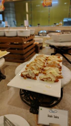 a plate of food sitting on a table at Efcee Sarovar Premiere Bhavnagar in Bhavnagar