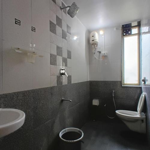 a bathroom with a toilet and a sink at Disha Villa in Alibag