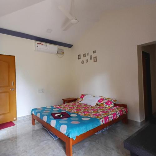 a bedroom with a bed in a room at Disha Villa in Alibag