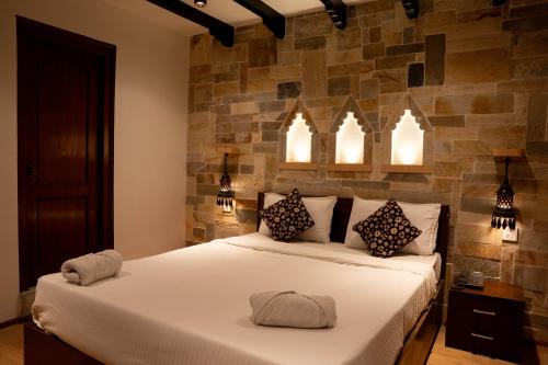 a bedroom with a large white bed with two pillows at Nag Pukhu Guest House in Bhaktapur