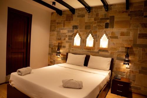 a bedroom with a bed with two hats on it at Nag Pukhu Guest House in Bhaktapur