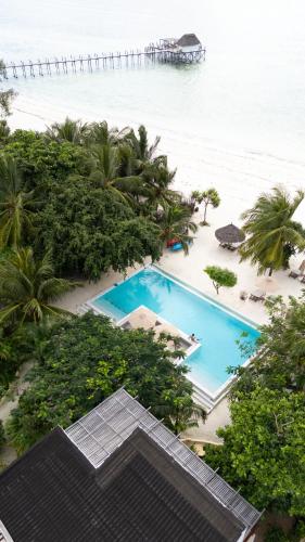 an aerial view of a resort swimming pool and the beach at Alma Boutique Hotel in Jambiani