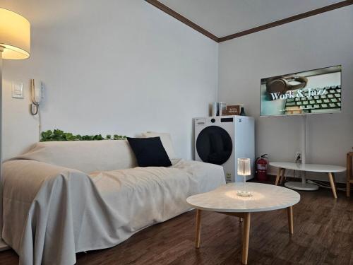 a living room with a bed and a table at Luna House in Gangneung
