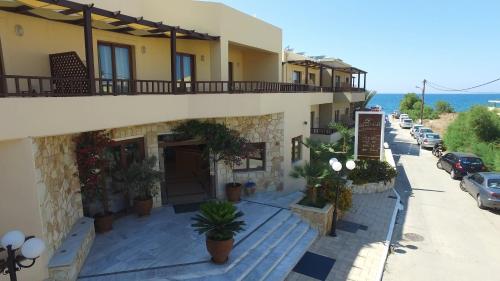a building with a balcony on the side of it at Indigo Mare in Plataniás