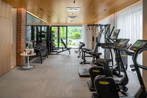 a fitness room with treadmills and cardio equipment at Seehotel Europa Resort in Velden am Wörthersee
