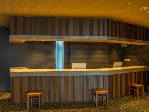 a lobby with a bar with two computers on it at KAMENOI HOTEL Oarai in Oarai