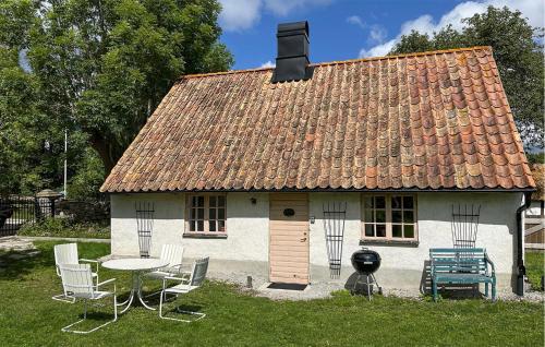 a small white house with a table and chairs at Stunning Home In Slite With Wifi - S42725 in Slite