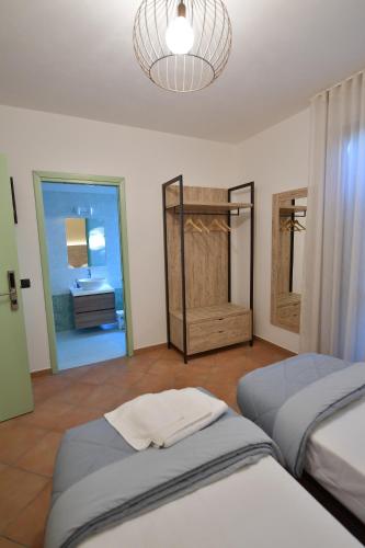 a bedroom with two beds and a bathroom at Hotel Vignale in Vignale