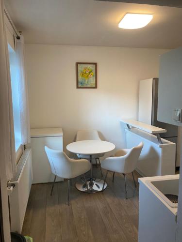 a kitchen with a table and chairs in a room at Apartmán Konštantínova in Prešov