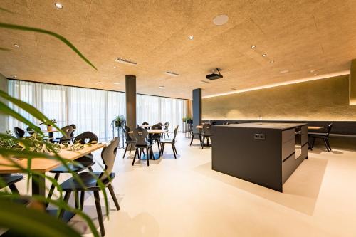 a restaurant with wooden ceilings and tables and chairs at Mountain Residence Montana in Santa Maddalena in Casies