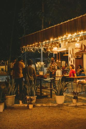 a group of people standing around a table with lights at Paddle Cult Surf & Yoga in Varkala