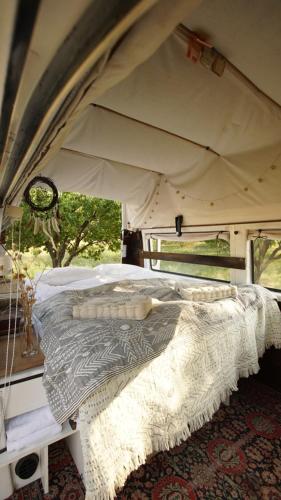 a bed in a tent in a room at Ratlook bus Sevan in Shorzha