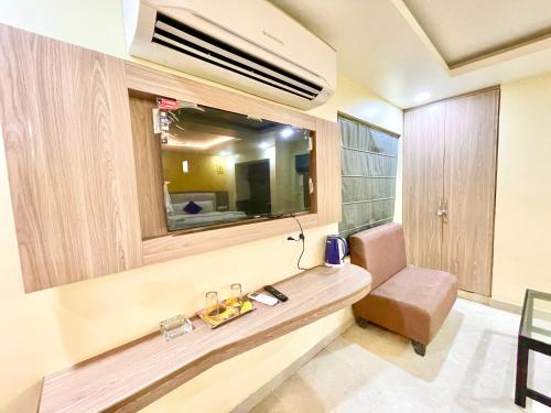 a bathroom with a sink and a mirror and a chair at Near Sea Beach HOTEL RB-INN ! Puri,Near Jagannath Temple- Fully Air conditioned Rooms ,Wifi,- Lift and Restaurant, Parking Facilities - A Top Rated Hotel IN PURI in Puri