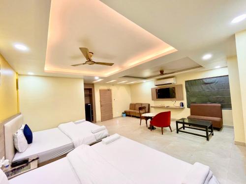 a living room with two beds and a chalkboard on the wall at Near Sea Beach HOTEL RB-INN ! Puri,Near Jagannath Temple- Fully Air conditioned Rooms ,Wifi,- Lift and Restaurant, Parking Facilities - A Top Rated Hotel IN PURI in Puri