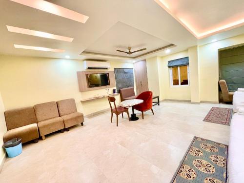 a living room with a couch and a table and chairs at Near Sea Beach HOTEL RB-INN ! Puri,Near Jagannath Temple- Fully Air conditioned Rooms ,Wifi,- Lift and Restaurant, Parking Facilities - A Top Rated Hotel IN PURI in Puri