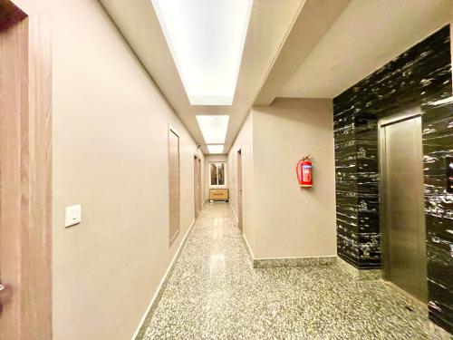a hallway with a fire hydrant in a building at Near Sea Beach HOTEL RB-INN ! Puri,Near Jagannath Temple- Fully Air conditioned Rooms ,Wifi,- Lift and Restaurant, Parking Facilities - A Top Rated Hotel IN PURI in Puri