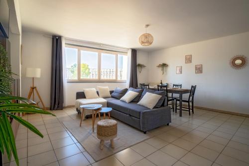 a living room with a couch and a table at Centre - Clim - Parking - Esplanade de l'Europe in Montpellier