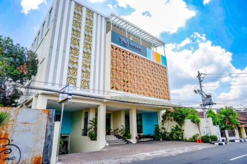 a building on the side of a street at Sans Hotel Nagari Malioboro in Yogyakarta