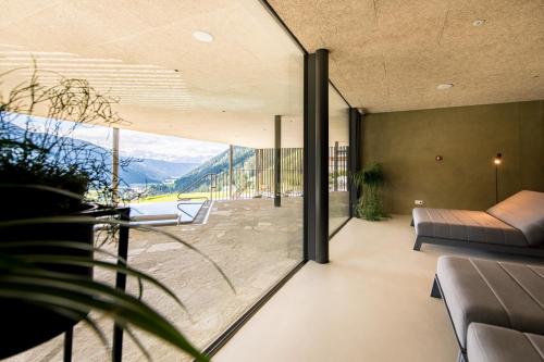 a house with a view of the mountains from the living room at Mountain Residence Montana in Santa Maddalena in Casies