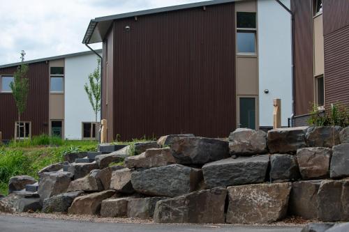 a stone retaining wall in front of a building at Kooparc vakantiepark in Giesbeek