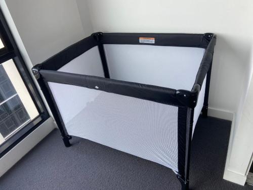 a small bed in a room next to a window at Southbank Hidden Gem in Melbourne