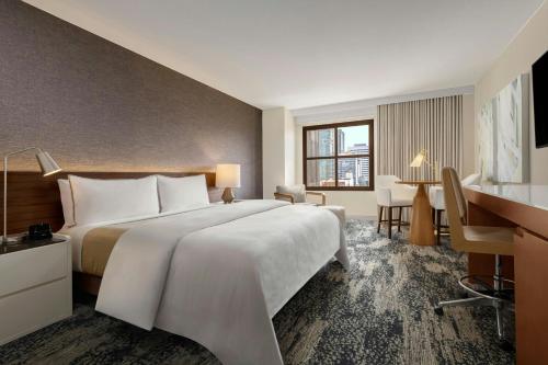 a hotel room with a large bed and a desk at The Westin San Diego Gaslamp Quarter in San Diego