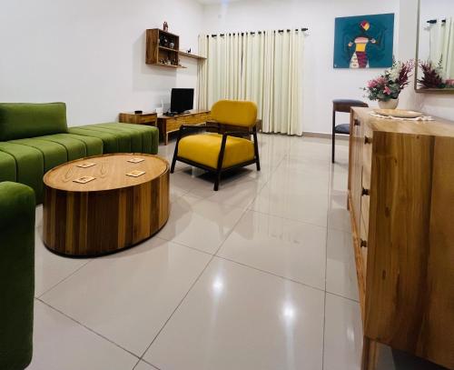 a living room with a couch and a table at Celestial Negombo Serviced Pool View Apartment in Negombo