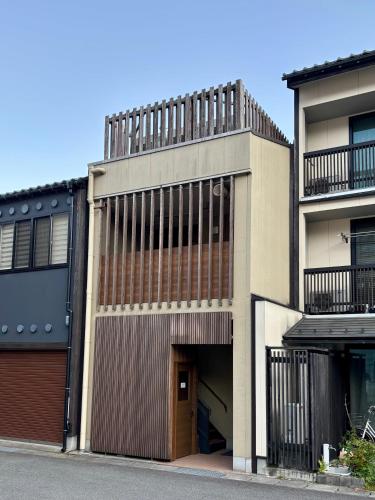 an apartment building with a garage and a building at 城崎 柳通り ゆるり-Yururi- in Toyooka