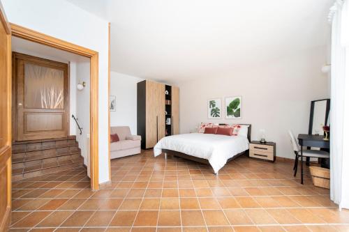 a bedroom with a bed and a couch and a table at Giulio in Campagnano di Roma